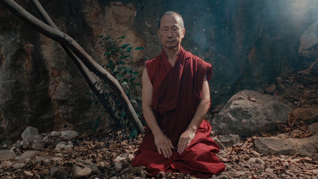 A Buddhist monk meditating in nature